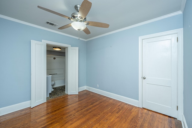 unfurnished bedroom featuring crown molding, connected bathroom, hardwood / wood-style flooring, and ceiling fan