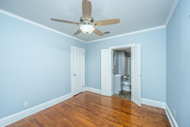 unfurnished bedroom with crown molding, ceiling fan, connected bathroom, and dark hardwood / wood-style floors