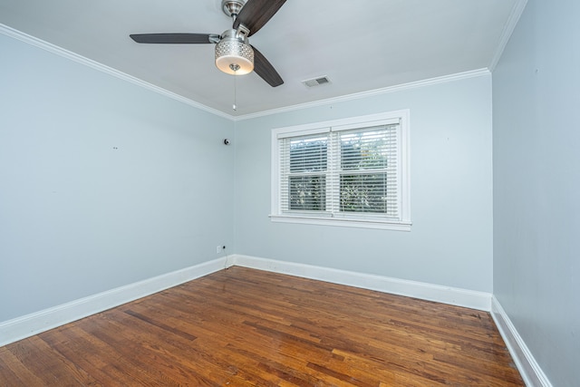 empty room with dark hardwood / wood-style flooring, crown molding, and ceiling fan