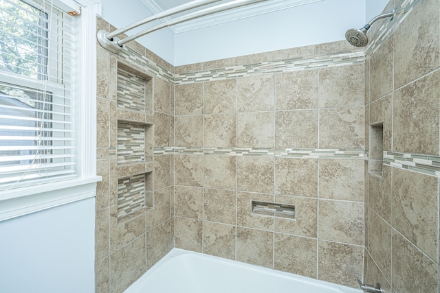 bathroom featuring tiled shower / bath combo and a wealth of natural light