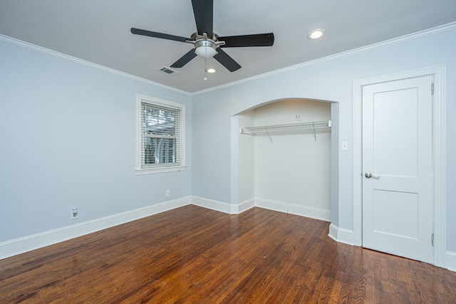 unfurnished bedroom featuring dark hardwood / wood-style flooring, ornamental molding, a closet, and ceiling fan