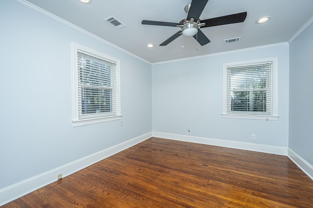 unfurnished room featuring ornamental molding, plenty of natural light, dark wood-type flooring, and ceiling fan