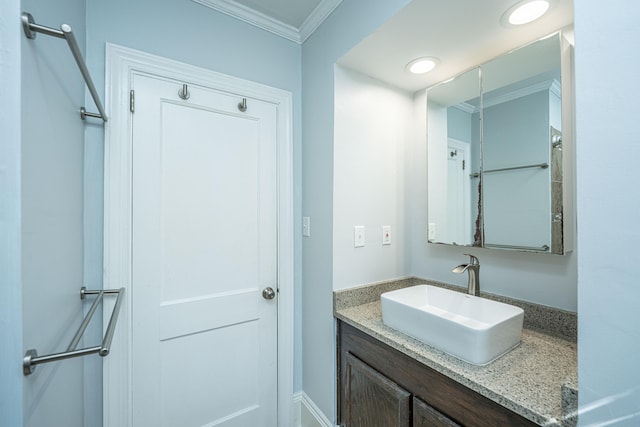 bathroom featuring ornamental molding and vanity