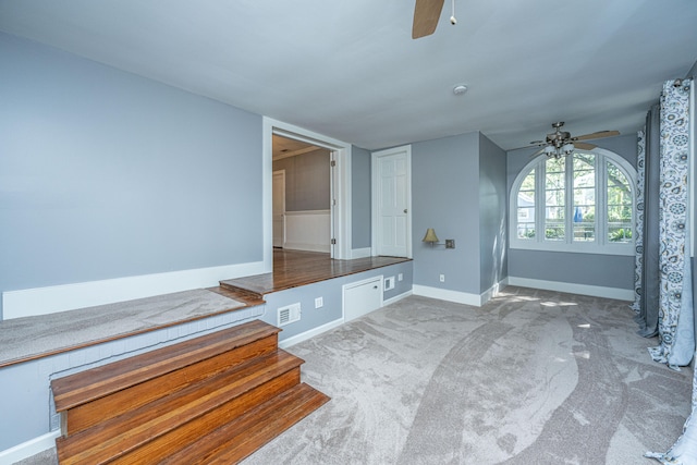 interior space featuring ceiling fan and carpet flooring