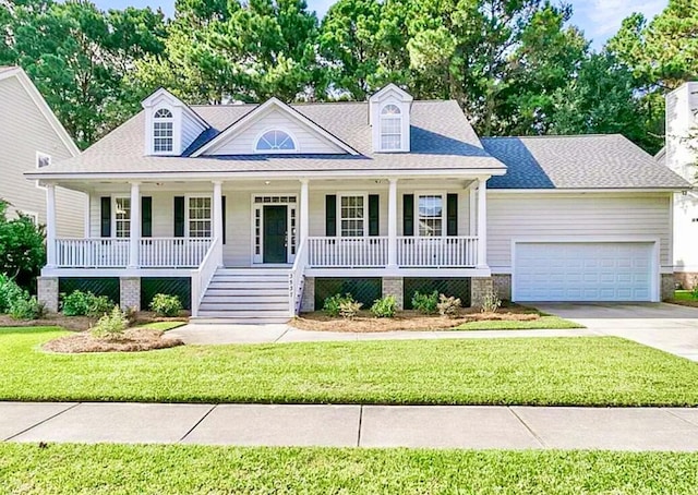 cape cod home with a garage, covered porch, and a front lawn