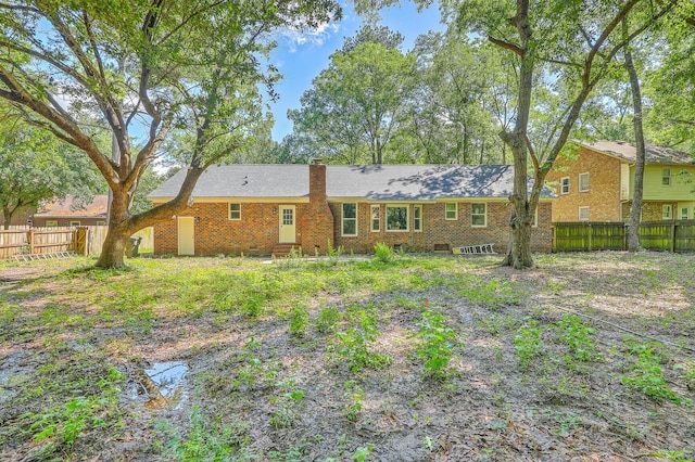 169 Southwold Cir, Goose Creek, SC 29445 - rear view of property with a fenced backyard, a chimney, and brick siding