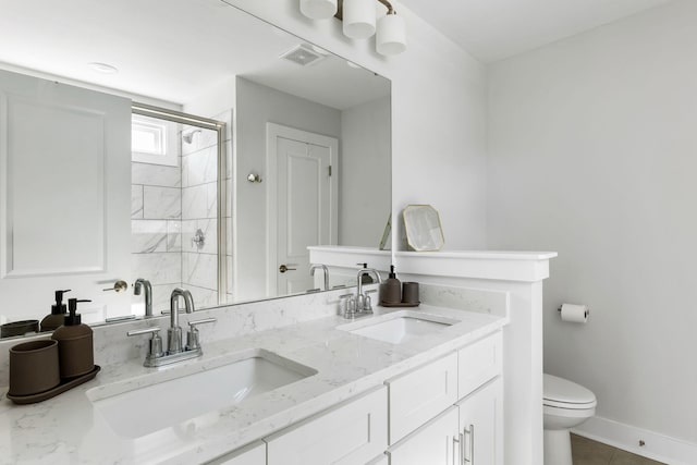 full bath with visible vents, a sink, a shower stall, and toilet