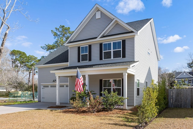 traditional home featuring driveway, a shingled roof, fence, and a porch