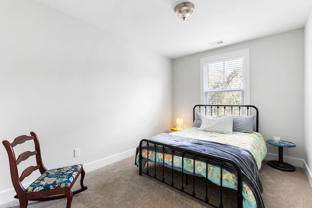 carpeted bedroom featuring visible vents and baseboards