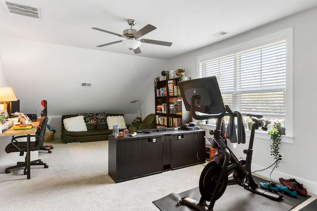 home office featuring light carpet, vaulted ceiling, and visible vents