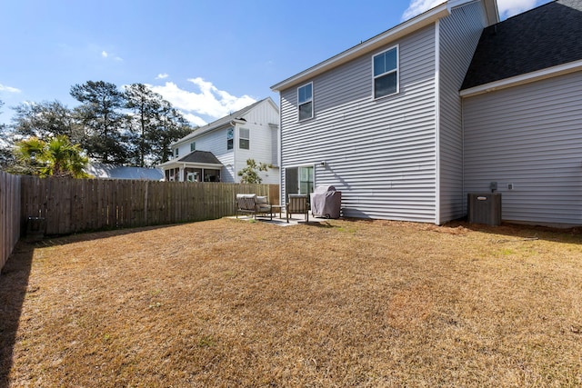 back of property with fence private yard, a patio area, and a lawn