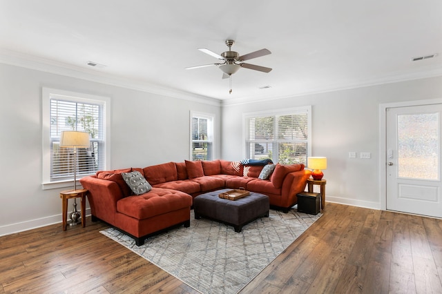 living room with light wood finished floors, visible vents, and ornamental molding