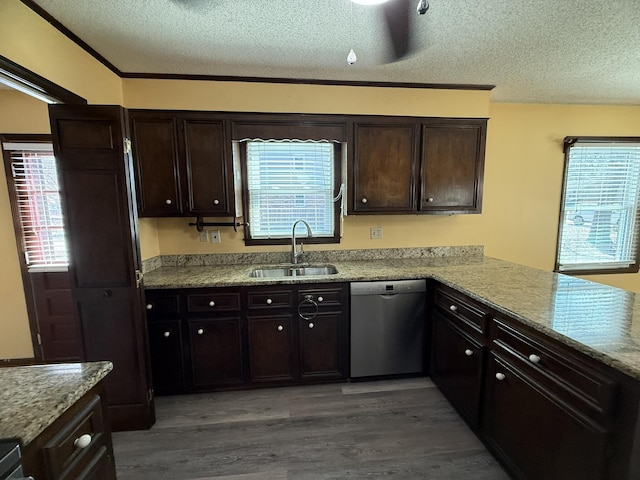 kitchen with stainless steel dishwasher, dark wood-type flooring, a sink, dark brown cabinets, and a peninsula