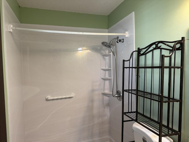 full bath with a textured ceiling and walk in shower