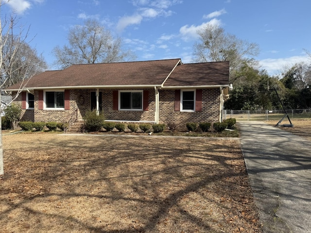 single story home with brick siding and fence