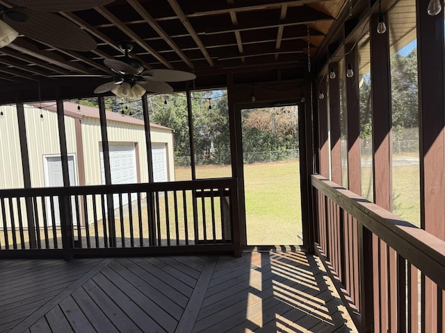 exterior space with ceiling fan and a lawn