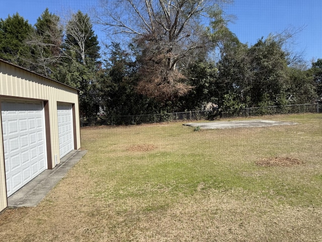 view of yard featuring a garage and fence