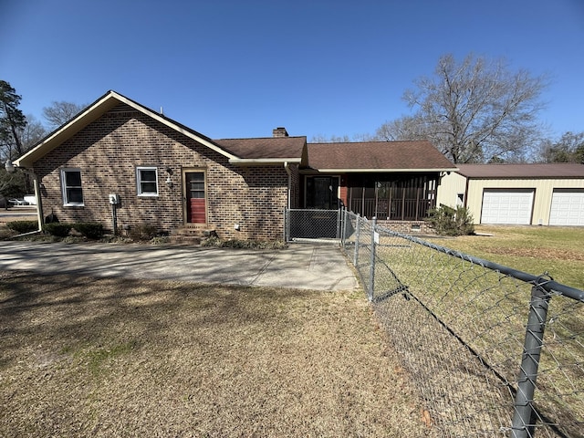 ranch-style home with brick siding, a chimney, a front yard, entry steps, and fence