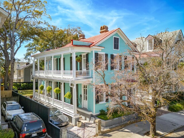 11 Franklin St, Charleston, SC 29401 - view of front of property featuring covered porch, a balcony, a fenced front yard, a chimney, and a gate