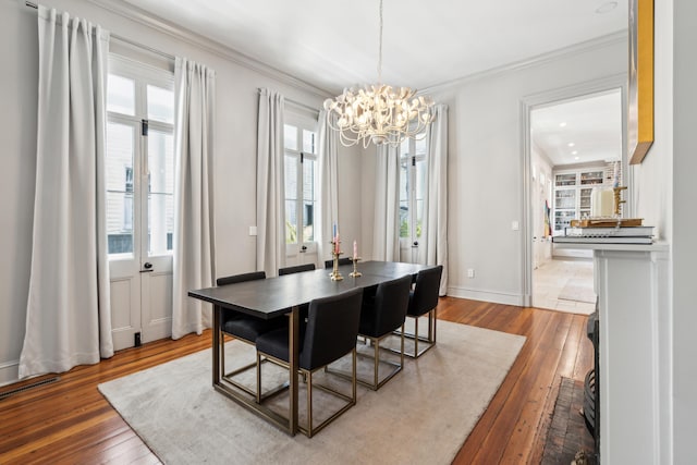 11 Franklin St, Charleston, SC 29401 - dining space with a chandelier, hardwood / wood-style floors, healthy amount of natural light, crown molding, and baseboards