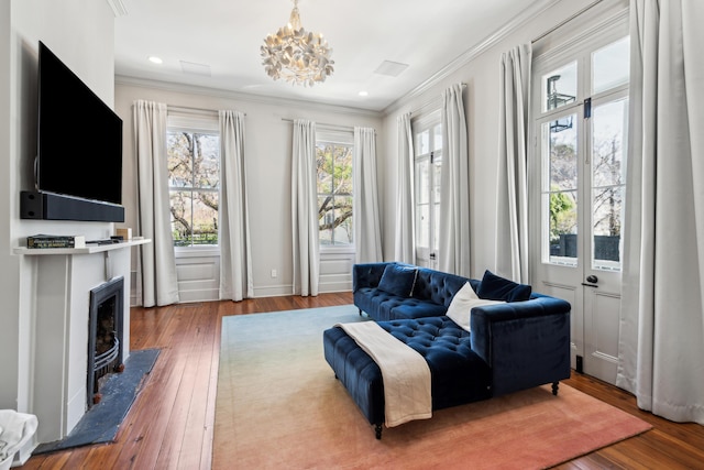11 Franklin St, Charleston, SC 29401 - living room featuring crown molding, hardwood / wood-style floors, a fireplace with flush hearth, recessed lighting, and a chandelier