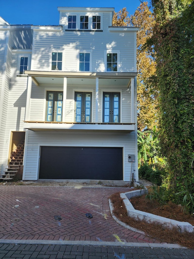 view of front of home with a garage and french doors