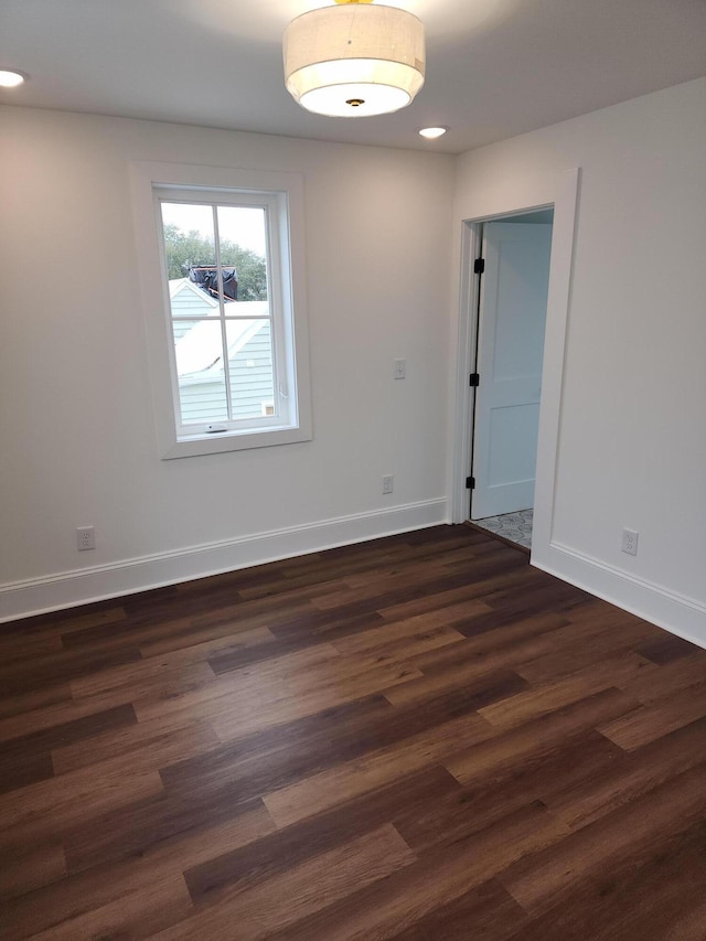 spare room with dark wood-type flooring