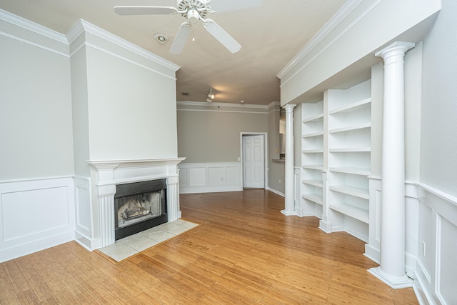 unfurnished living room with ceiling fan, ornamental molding, and light hardwood / wood-style flooring