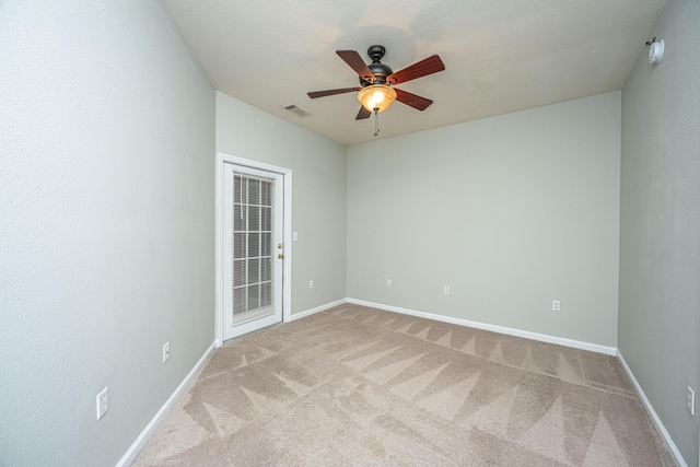 carpeted spare room with ceiling fan