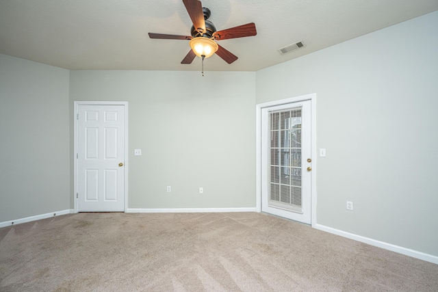 carpeted empty room featuring ceiling fan