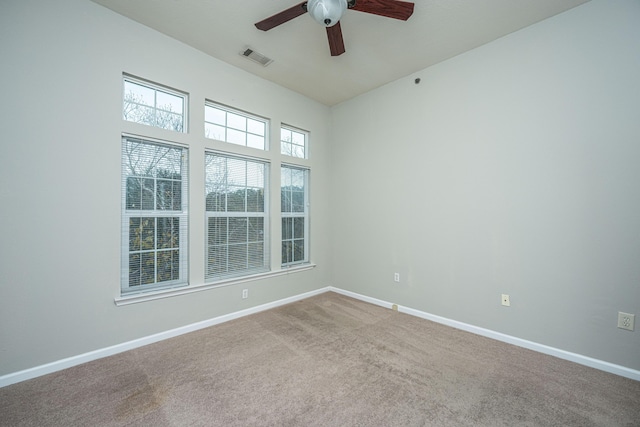 spare room with ceiling fan and carpet floors