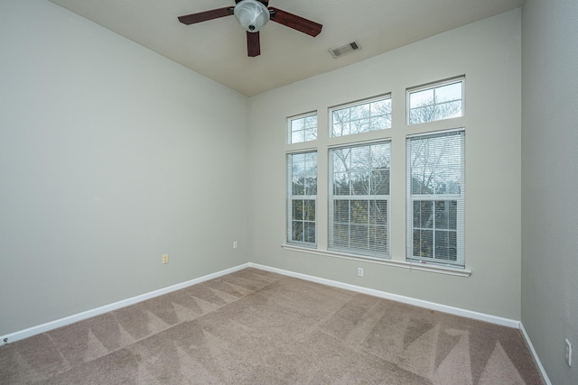 unfurnished room with carpet flooring and ceiling fan