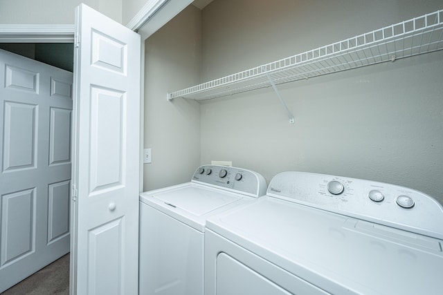 laundry area with washing machine and dryer and carpet floors