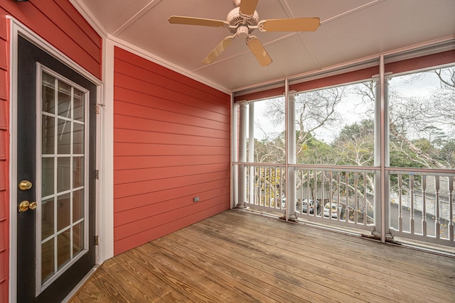 unfurnished sunroom featuring ceiling fan