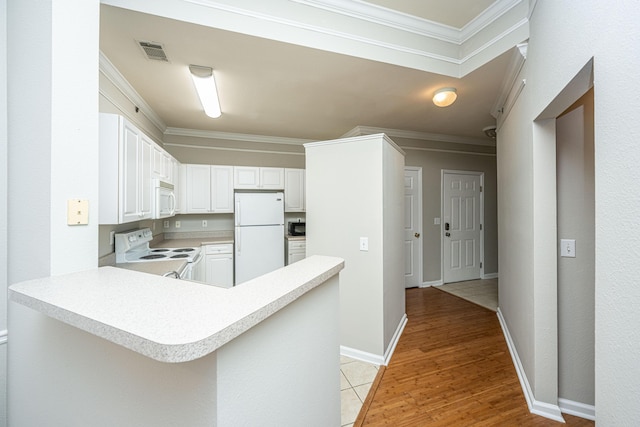 kitchen with white cabinetry, kitchen peninsula, crown molding, white appliances, and light wood-type flooring