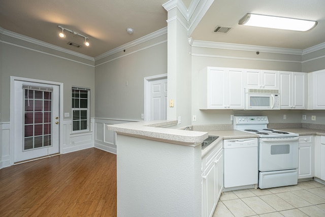 kitchen featuring kitchen peninsula, light wood-type flooring, white appliances, and white cabinets