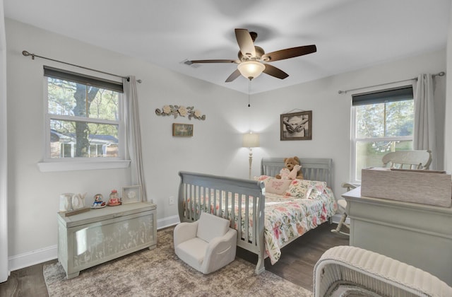 bedroom with ceiling fan and dark hardwood / wood-style flooring