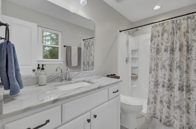 bathroom featuring vanity, toilet, and walk in shower