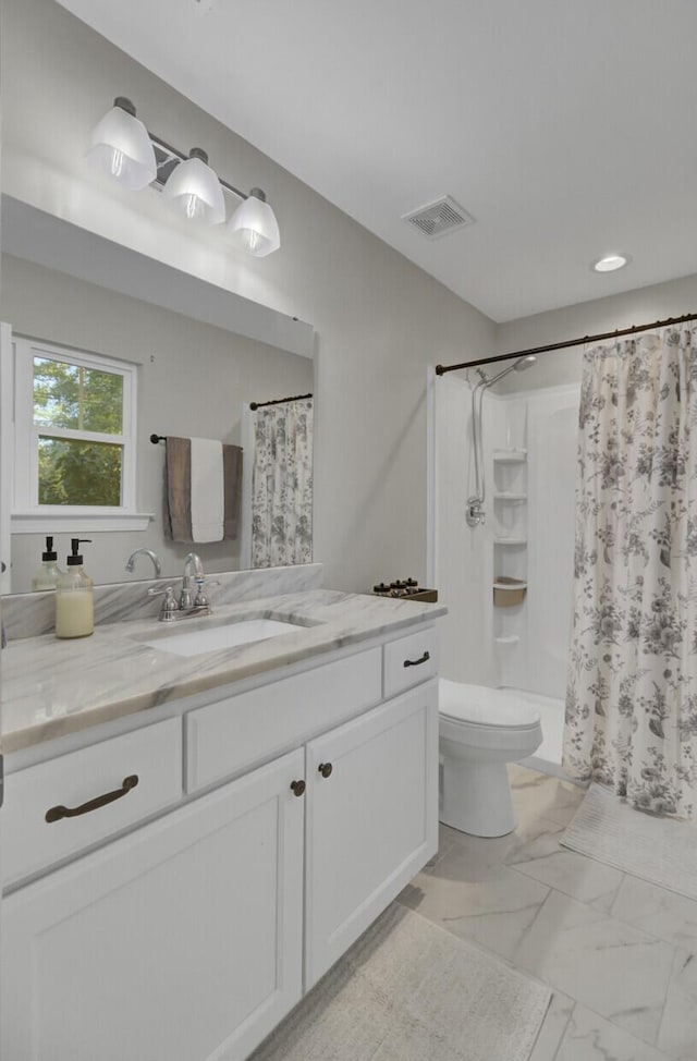 bathroom featuring a shower with shower curtain, vanity, and toilet