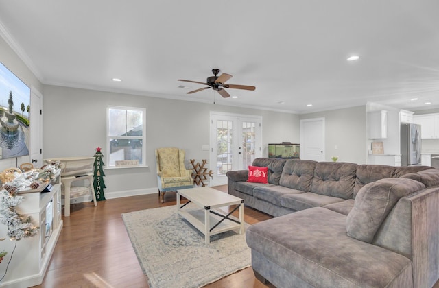 living room featuring ceiling fan, dark hardwood / wood-style flooring, crown molding, and french doors