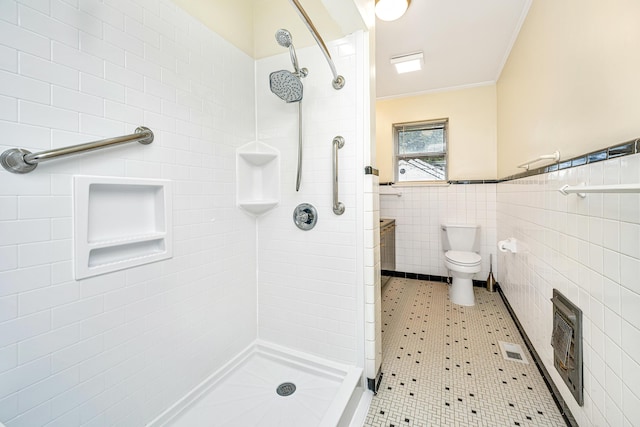 bathroom featuring visible vents, ornamental molding, heating unit, a shower stall, and tile walls