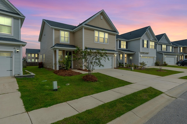 view of front of property featuring a garage and a yard