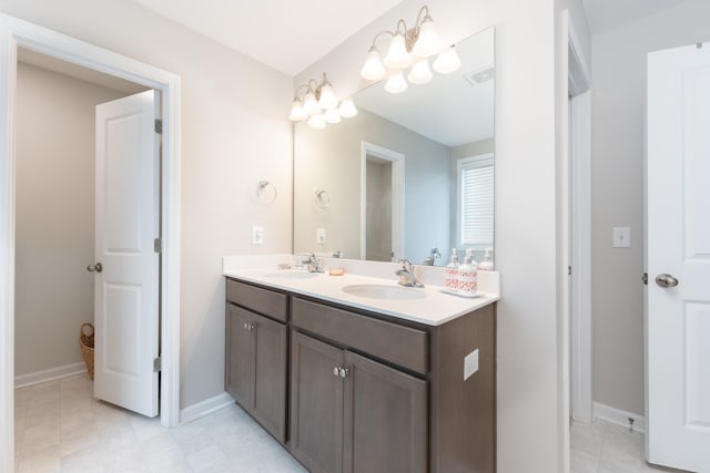 bathroom with an inviting chandelier and vanity