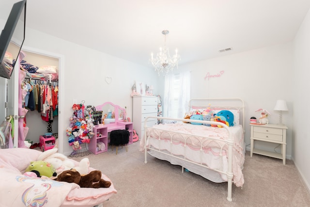 bedroom with light carpet, a closet, and a notable chandelier