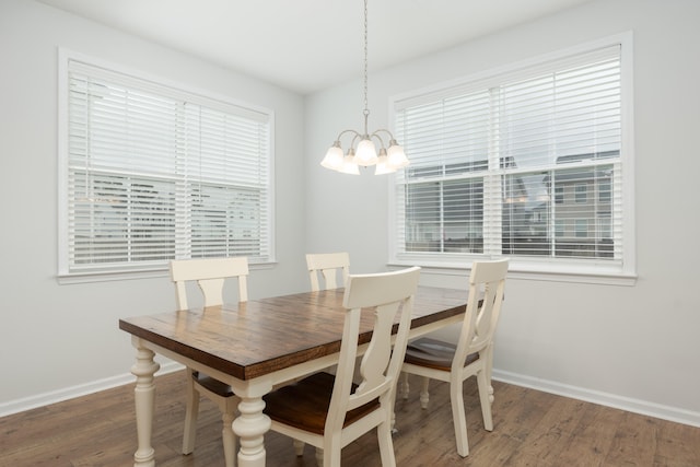 dining room featuring dark hardwood / wood-style flooring and a notable chandelier