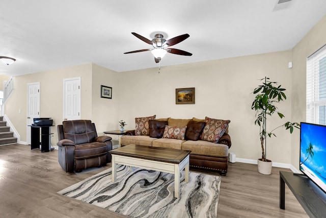 living room featuring ceiling fan and wood-type flooring