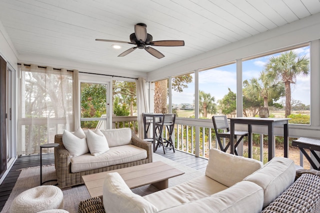 sunroom featuring wood ceiling and ceiling fan