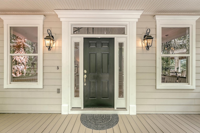 view of exterior entry with covered porch