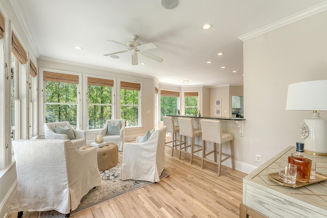 living room featuring recessed lighting, light wood finished floors, crown molding, and a ceiling fan