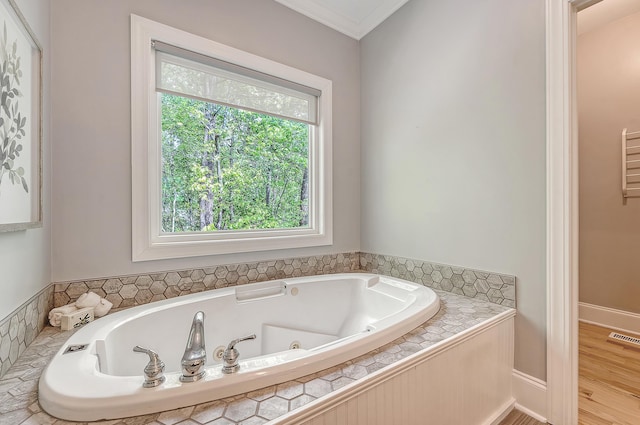 full bath featuring crown molding, a whirlpool tub, and visible vents